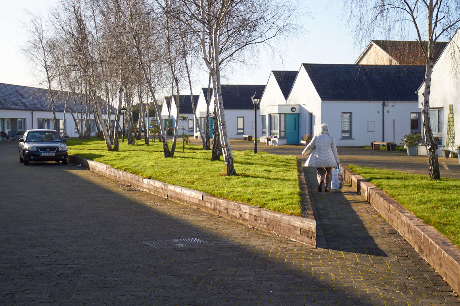 Lady walking to her house with groceries