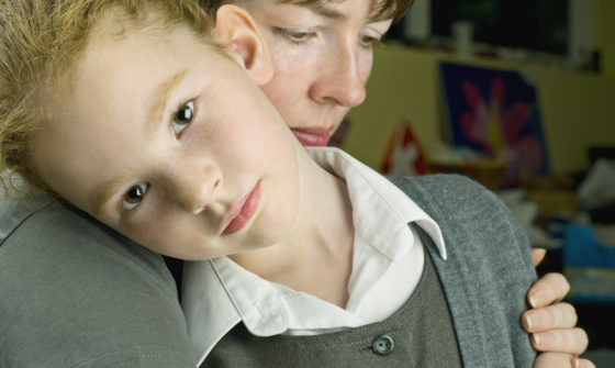 Get Help - A lady holding her sad little daughter