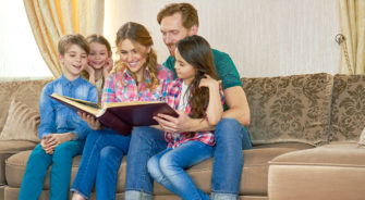 A happy family holding a book
