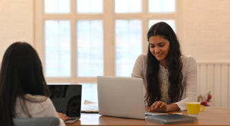 University students are doing e-learning while sitting together