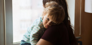 A child being comforted by her mom