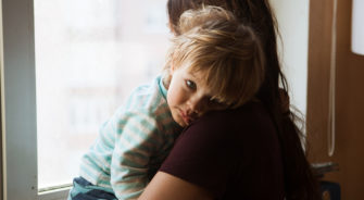 A child being comforted by her mom