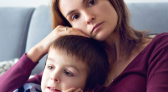 Young mother, holding her little sick boy