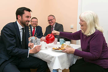 Lady pouring tea for man