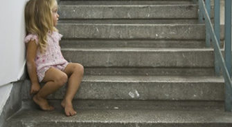 A young girl sitting on the step