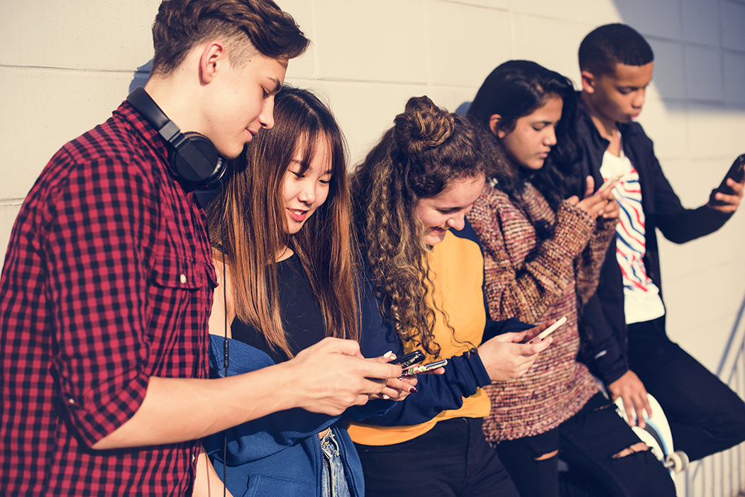 A group of young people on their phones