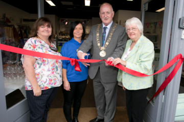 Four people cutting a ribbon