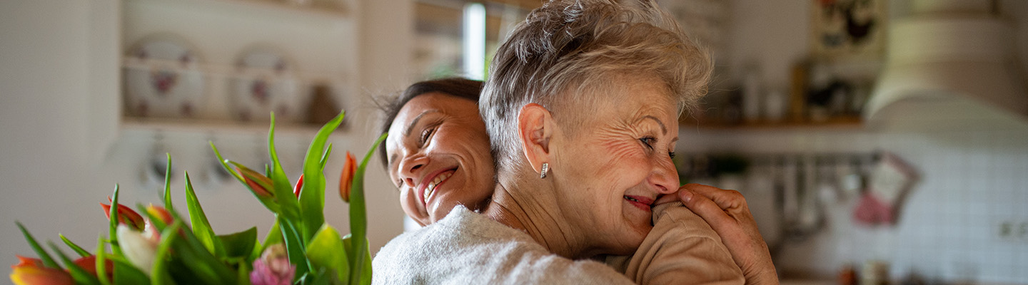 A mother and daughter HUGGING