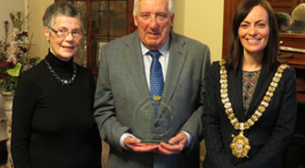 Three people winning an award