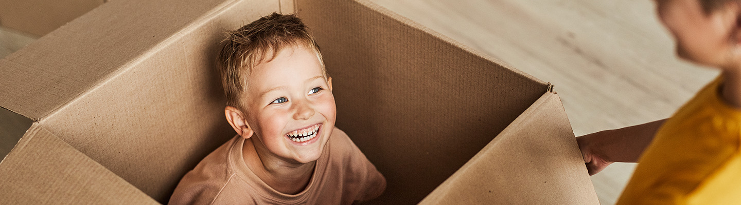 Two kids playing with a box