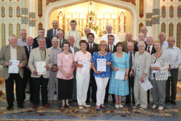 Many people standing at a church altar