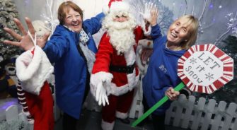 A santa with two women