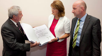 SVP member presenting a book to the minister