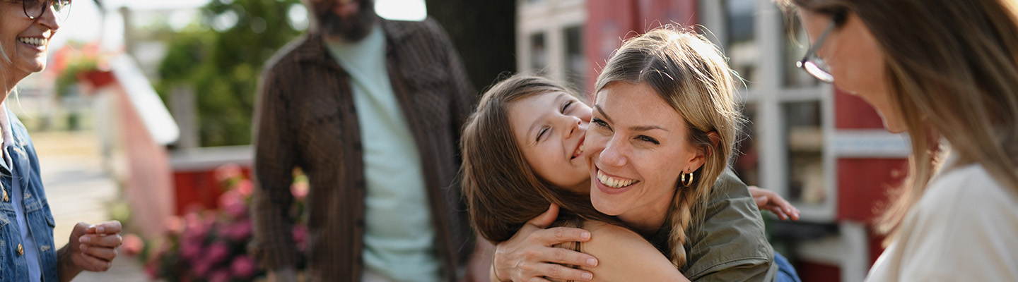 A mother hugging her daughter