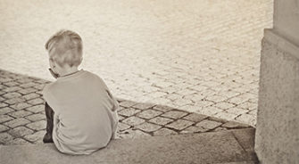 A child sitting on a step alone