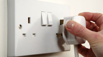 A plug entering a socket