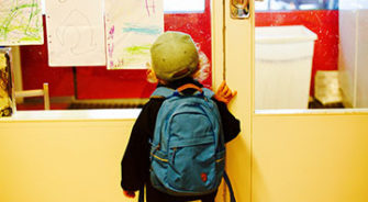 A child opening the door in a school