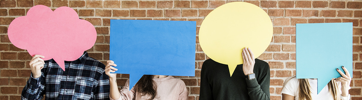 People covering their faces with paper