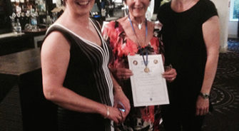Rita farrell receiving an award