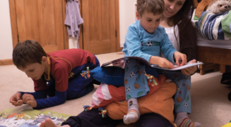 Kid playing on his mother's lap