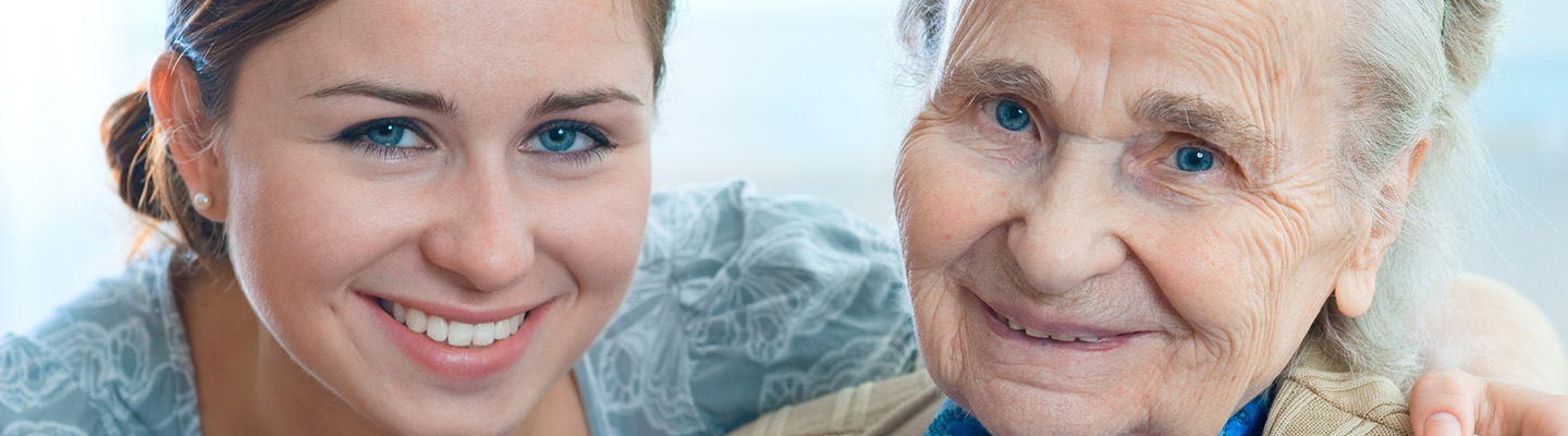 A mother and daughter smiling