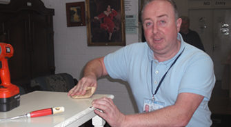 A man cleaning a table