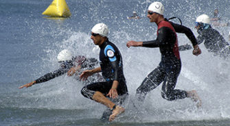 People jumping into the ocean for a swim