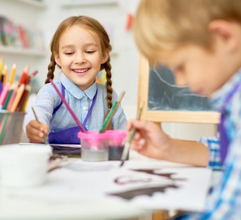 Early Years Education - Two kids painting in school
