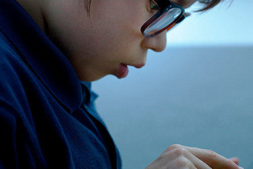 A kid playing on his phone