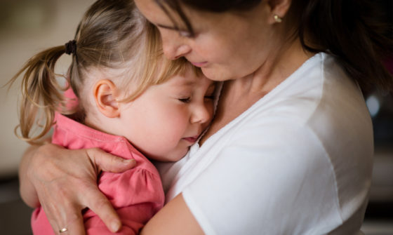 A mother embracing her daughter