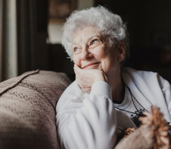 An old lady looking out through the window