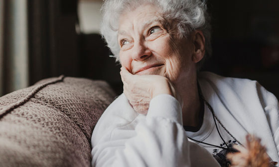 An old lady looking out through the window