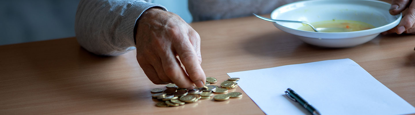 An old man counting his coins