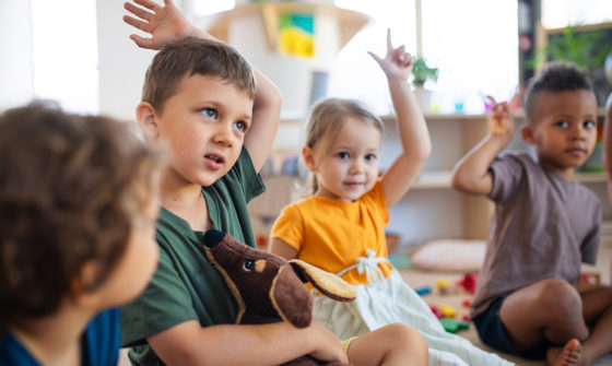 Kids at a school raising their hands