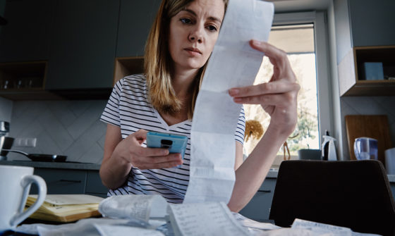 A distressed lady calculating her expenses