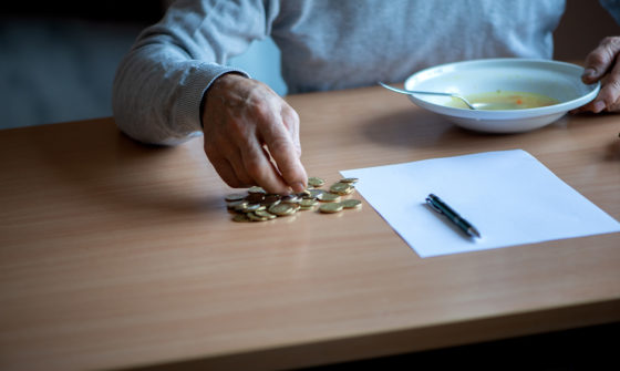 An elder person counting coins