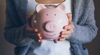 A lady holding a piggy bank