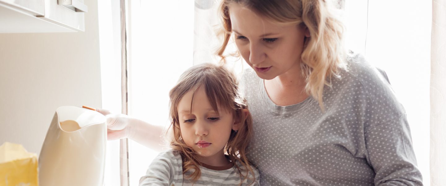 A mother cooking with her daughter