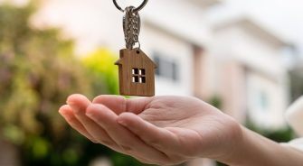 A person levitating a house key