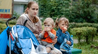 a-young-mother-and-her-two-children-are-walking-on