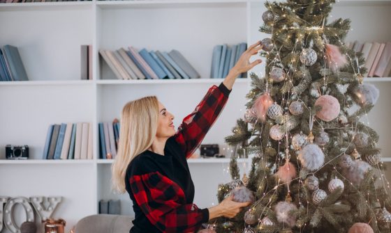Corporate Giving | Employee decorating Christmas Tree