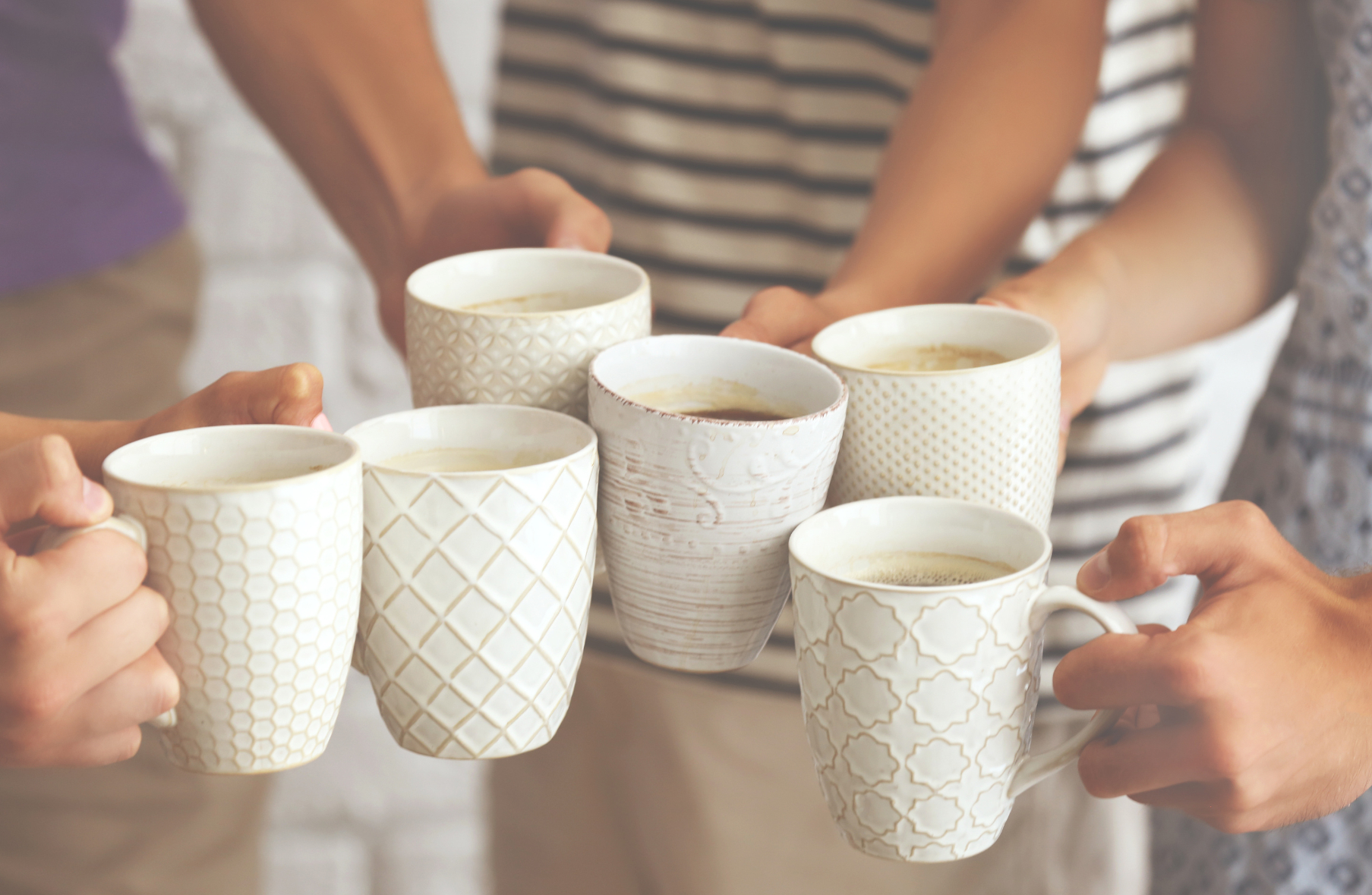 Coffee morning img A group of people holding cups of coffee