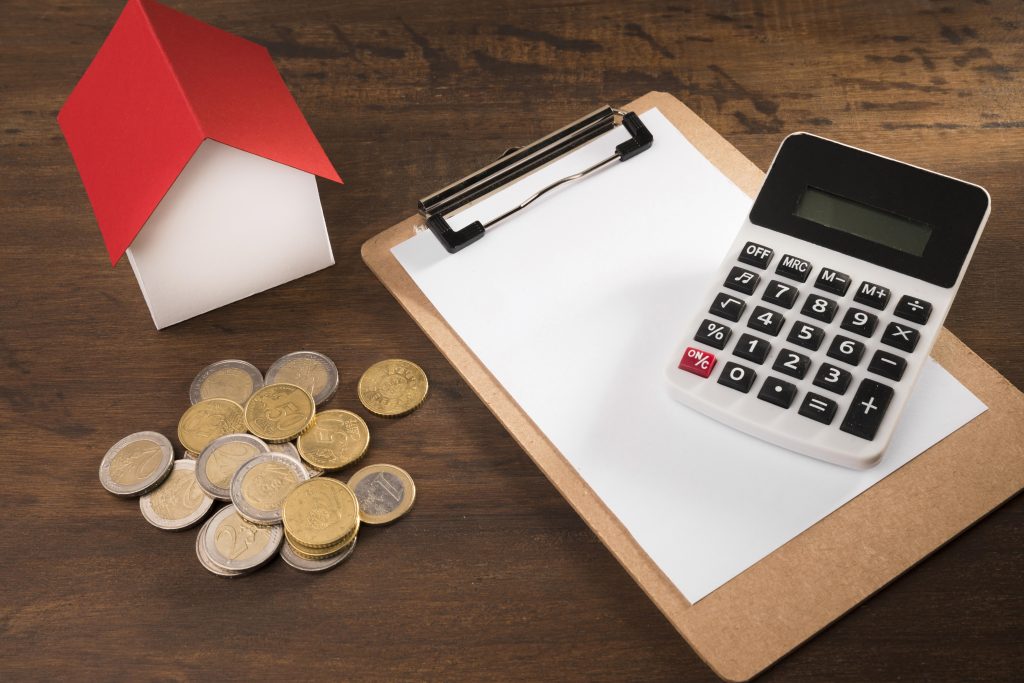 calculator, house and coins