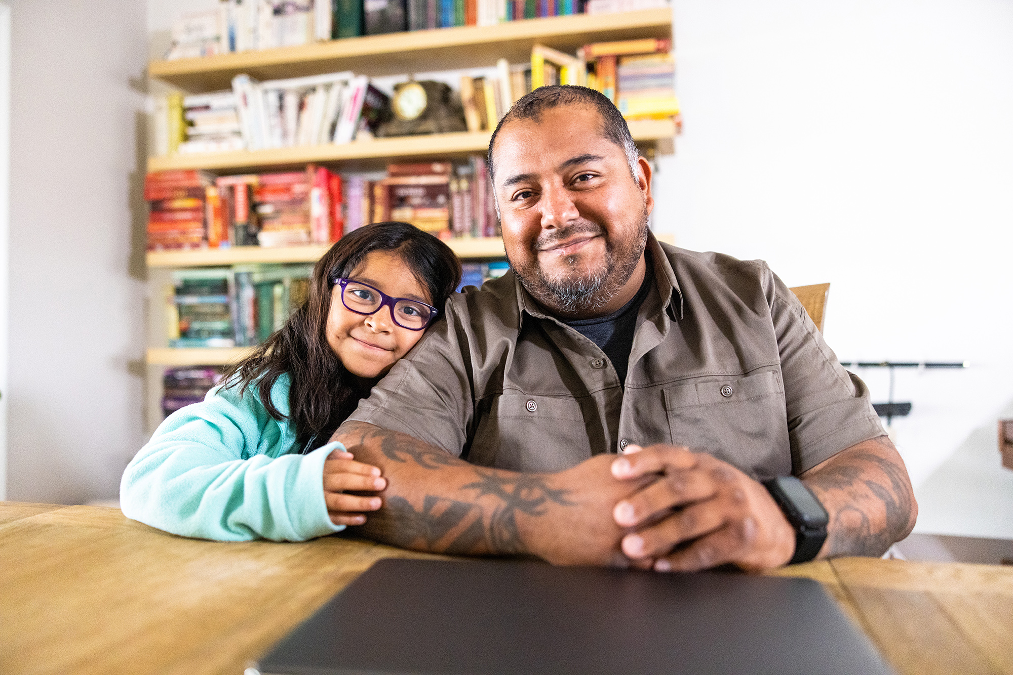 Impact Stories - A Hispanic American veteran double amputee on a laptop