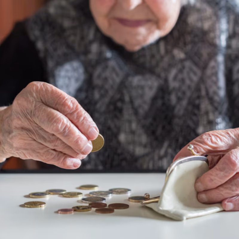 Elderly woman counting money-April 2026 Elderly lady counting